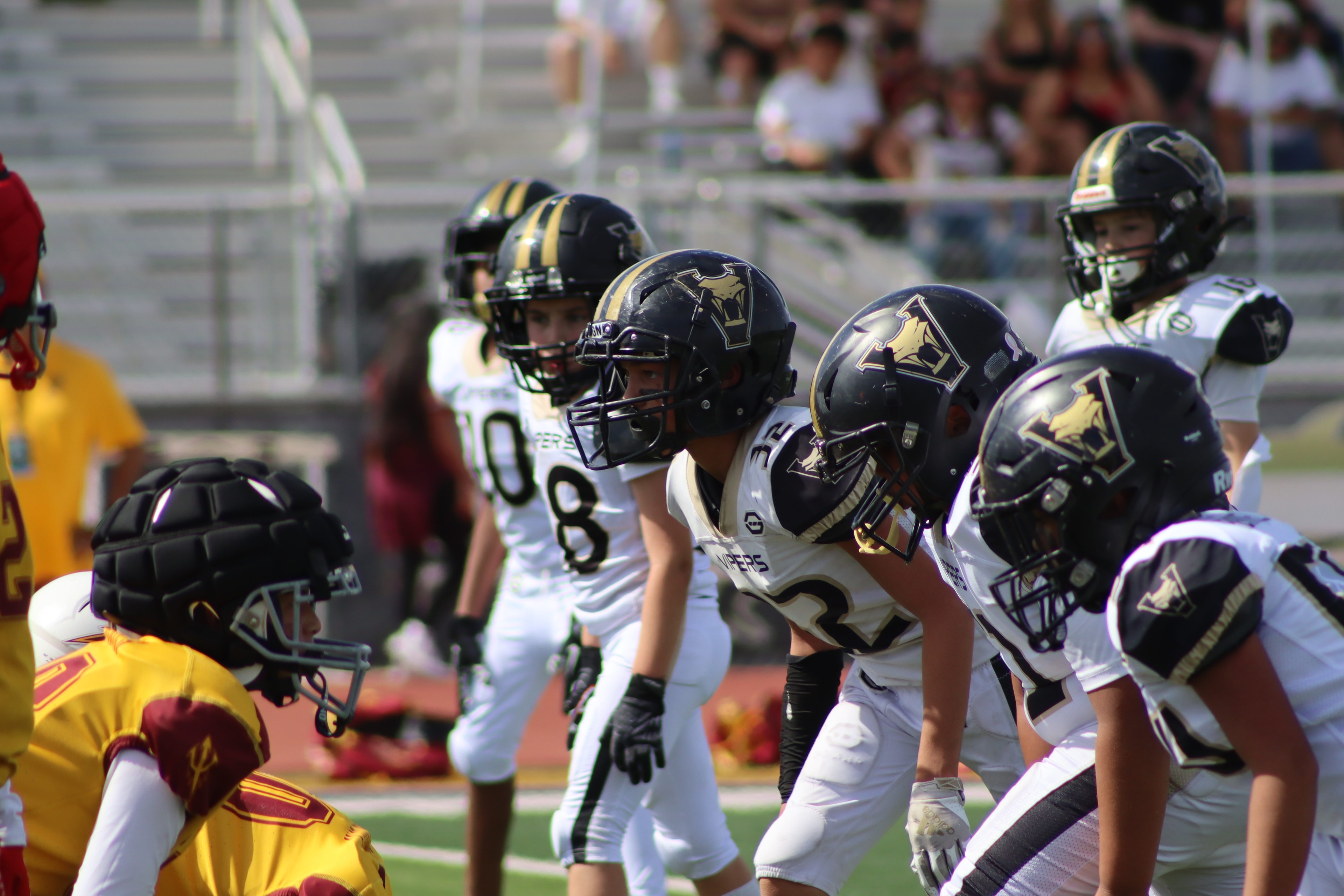 Youth athletes training with coach on field